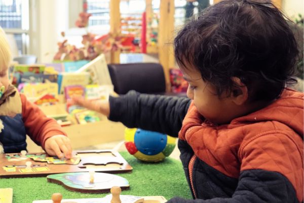 Educator and child engaged in a learning experience at Meraki